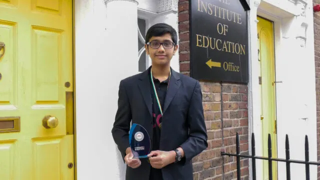 Sumukh Adiraju holding his trophy