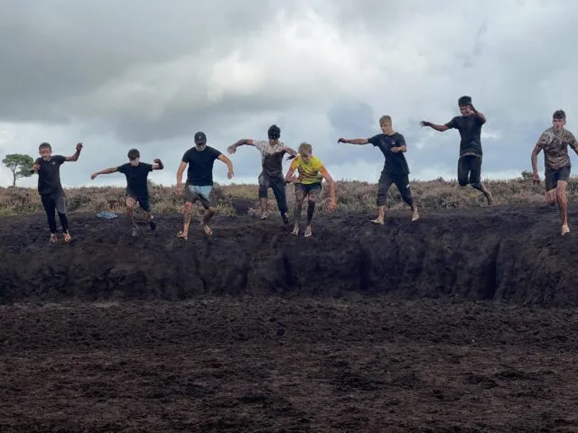 4th years jumping into mud