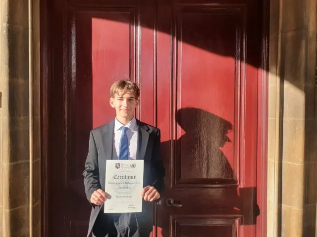 Edward-with-his-Distinguished-Delegate-Award-Tues-2-scaled-1