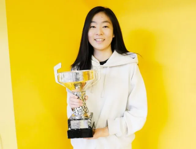 Yolanda Chao holding her trophy