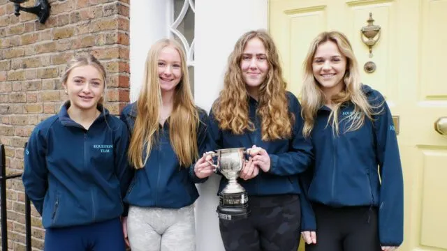 The equestrian team showing their trophy
