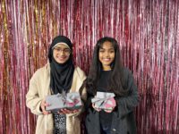2 students with wrapped gifts