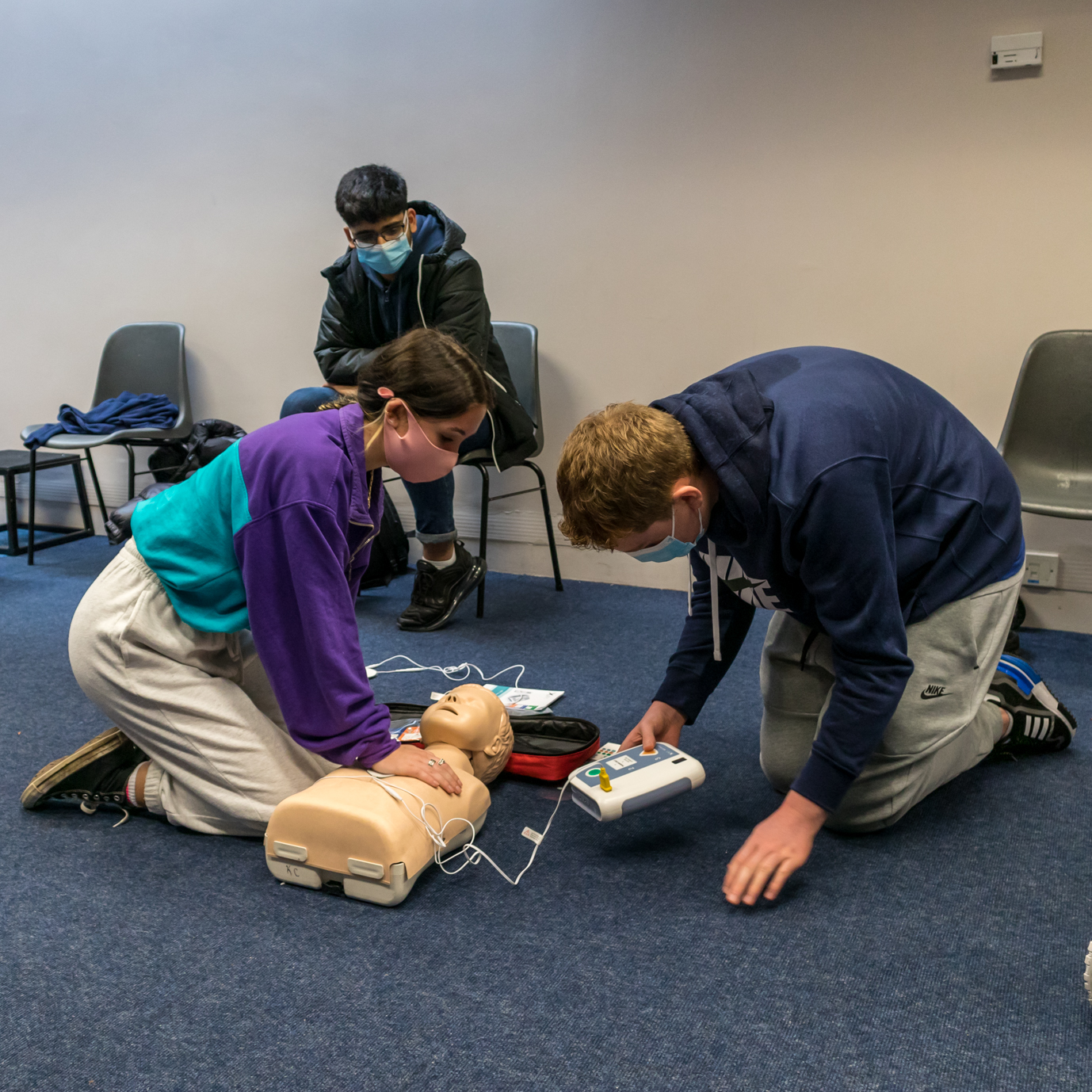 Instructor teaching student CPR one on one