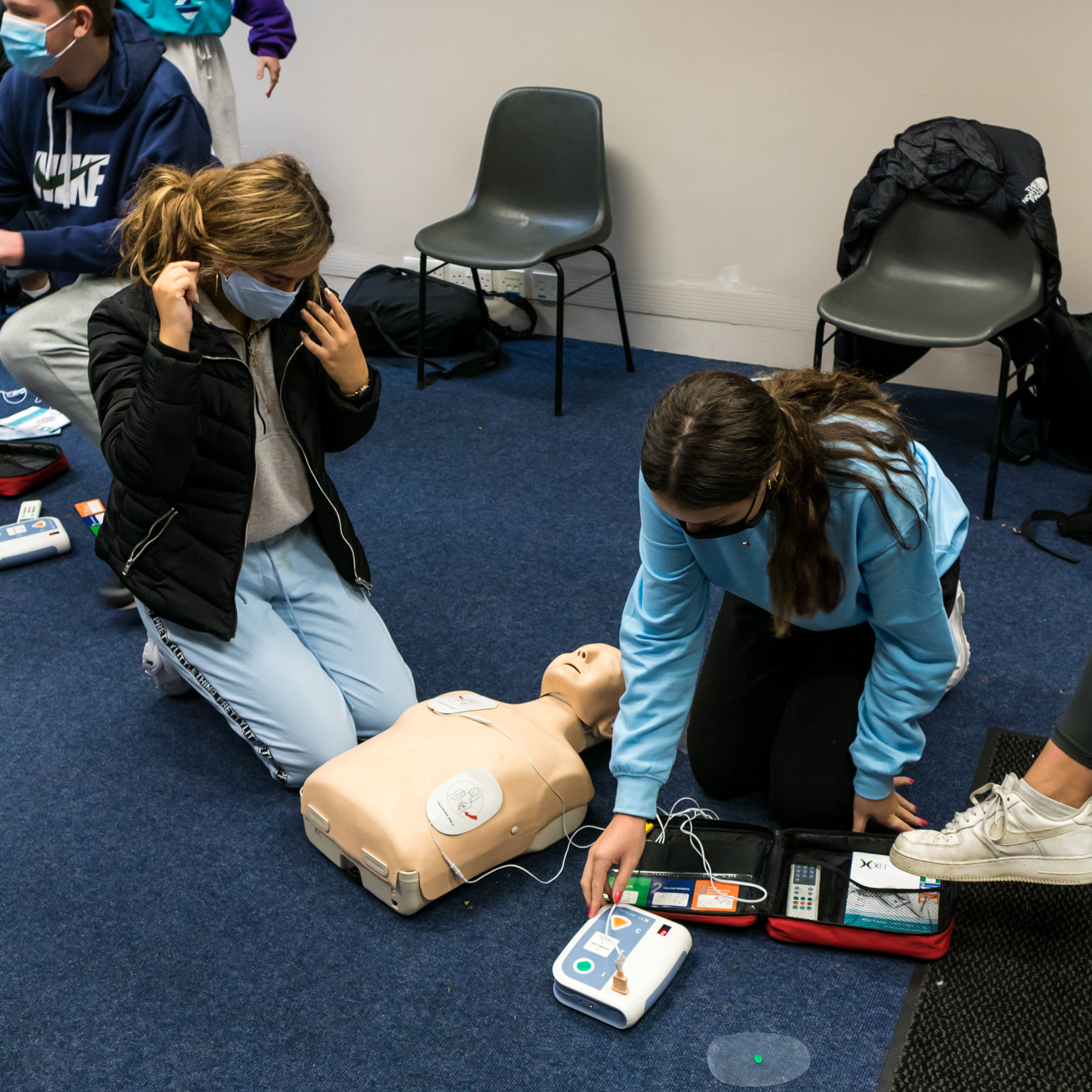 Students Practicing CPR together