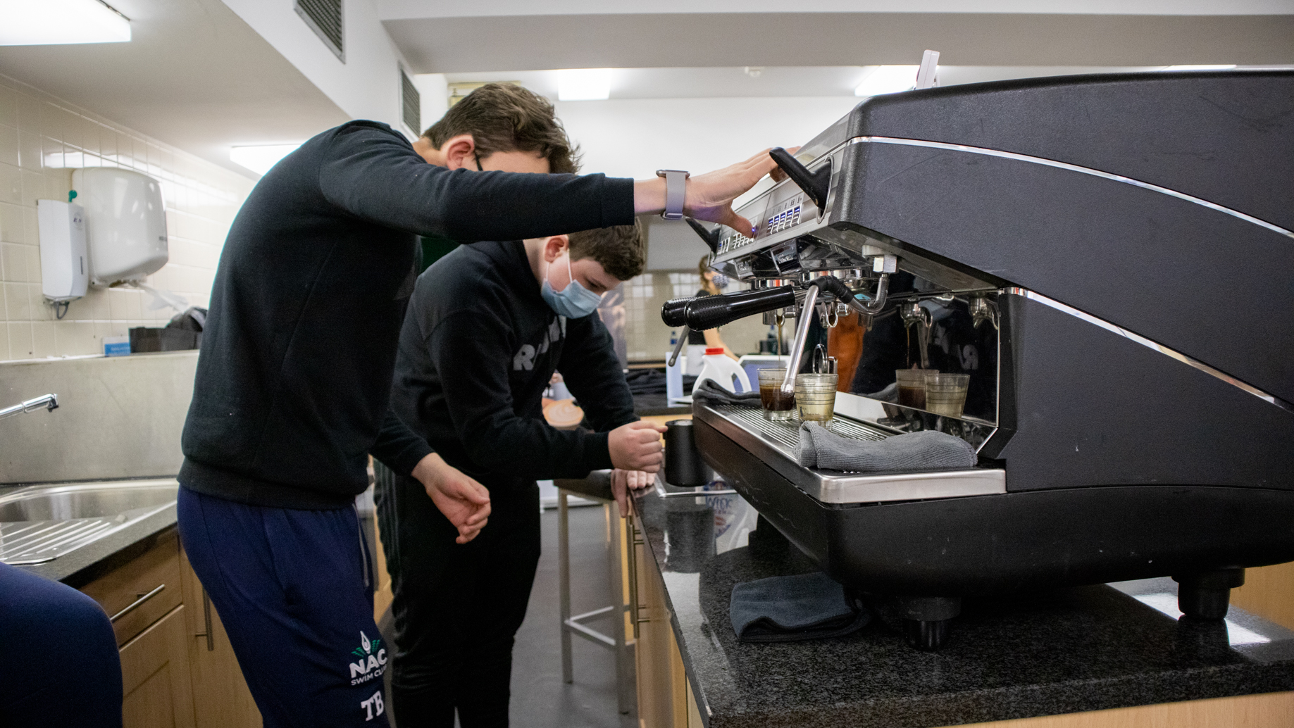 Students inspecting coffee maker