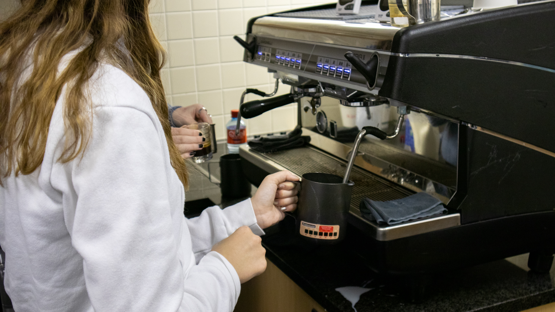 Student steaming milk
