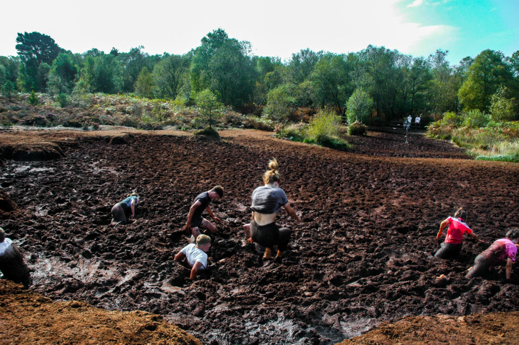 Students jumping into mud