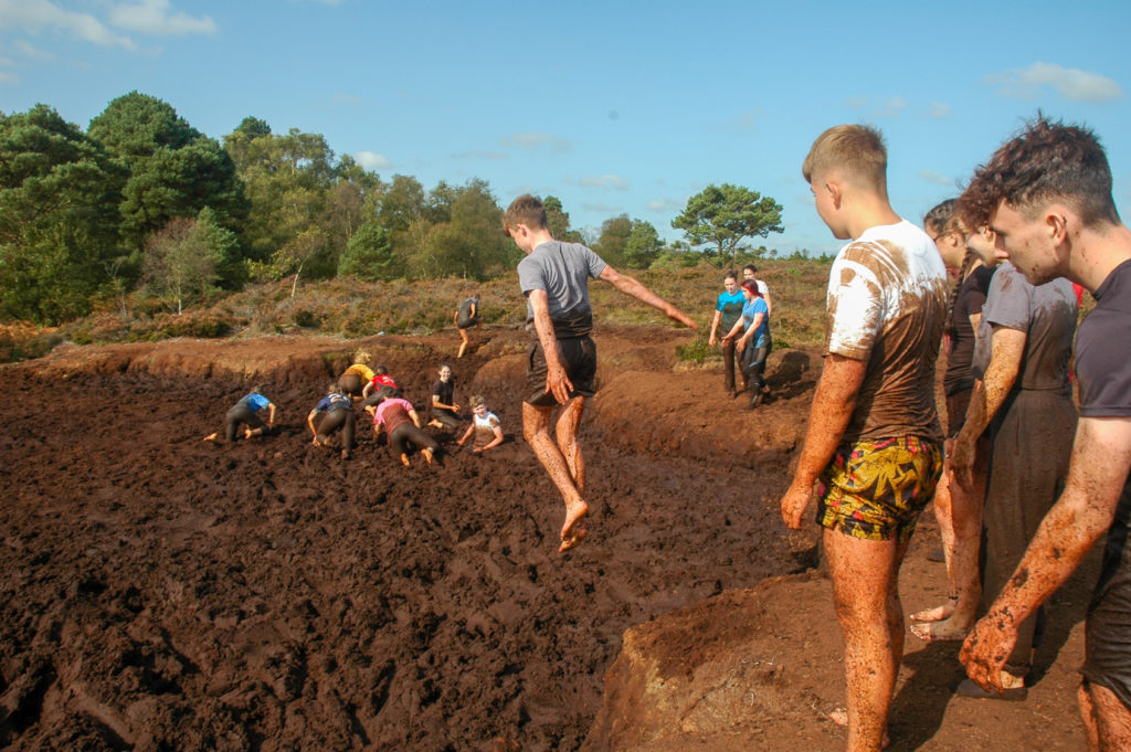 Students Jumping into Mud