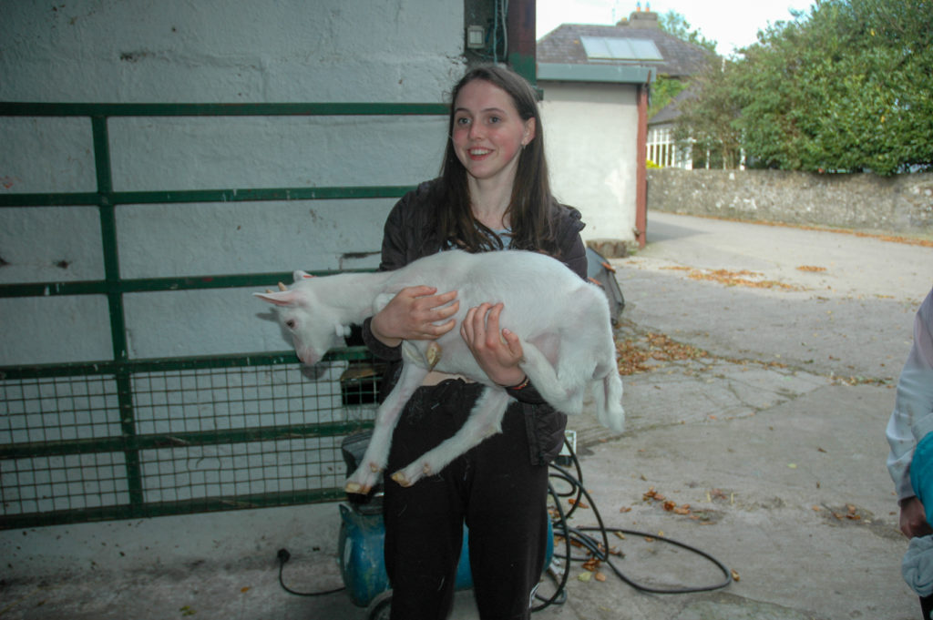 Student lifting Goat