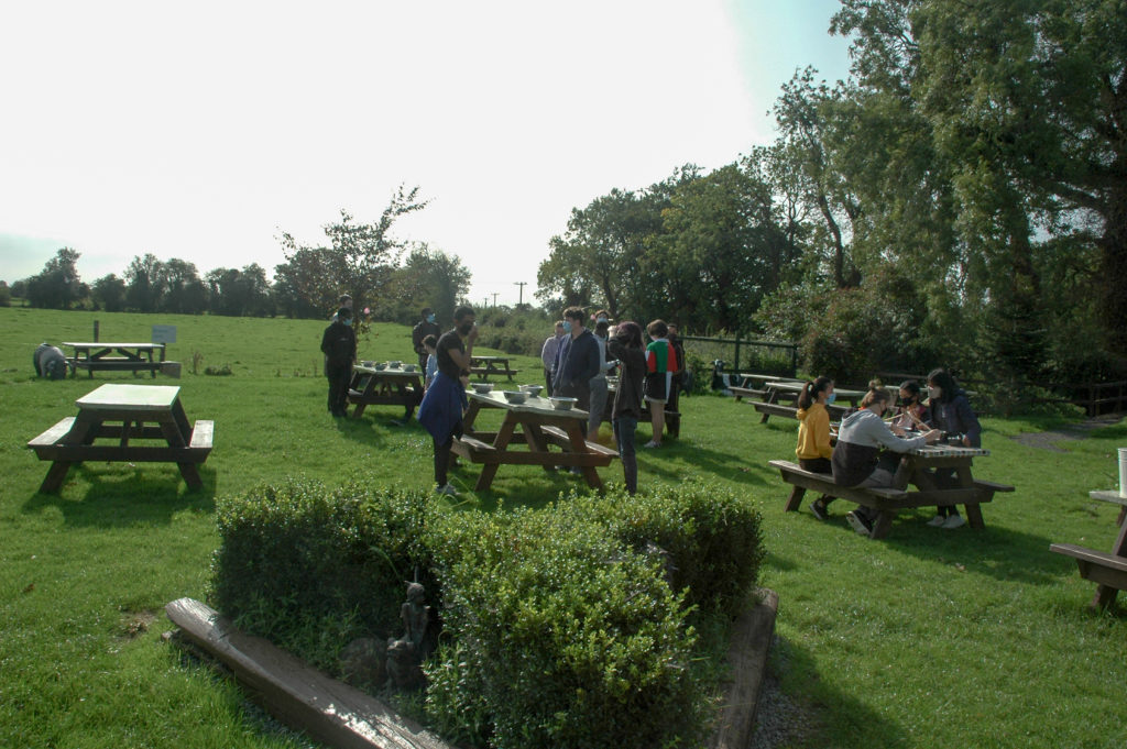 Students outside sitting on benches