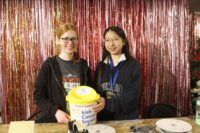 two students with a donation bucket