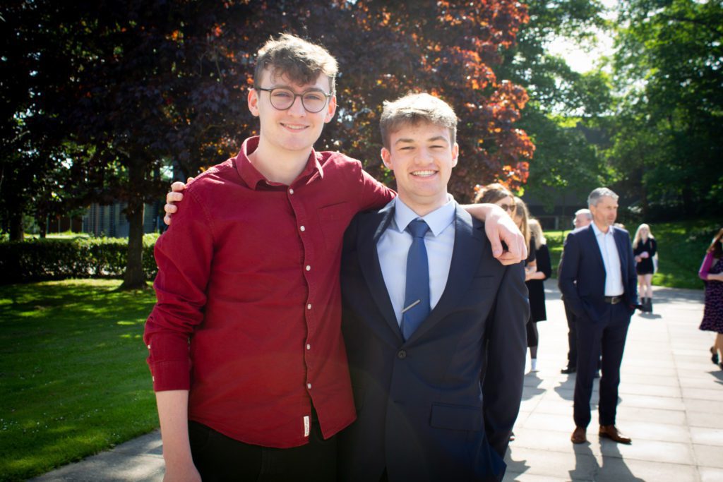 2 men posing for photo
