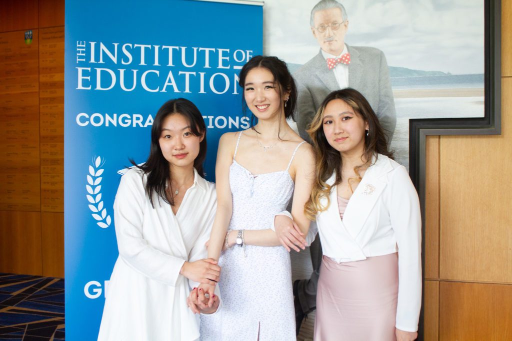 Three students posing for graduation photo