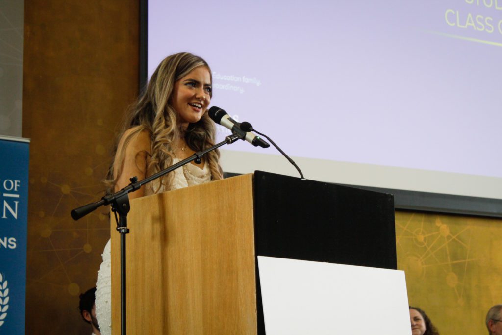 Photo of a woman giving a speech at a podium