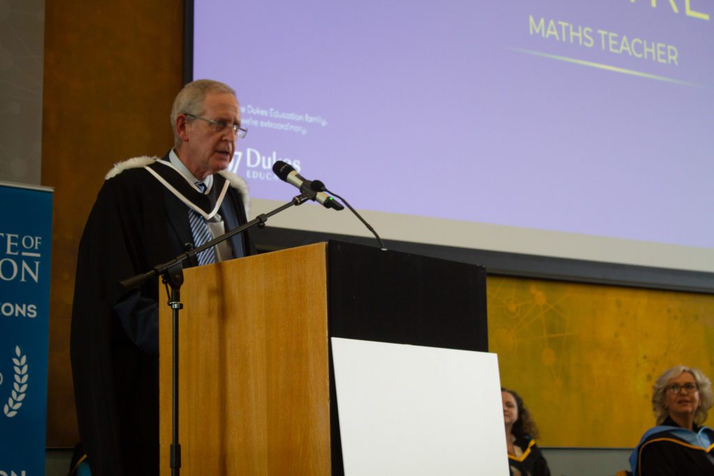 Photo of a man giving a speech at a podium