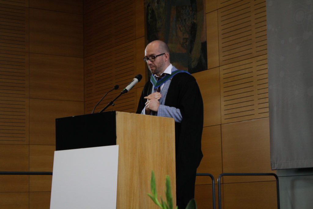 Photo of a man giving a speech at a podium