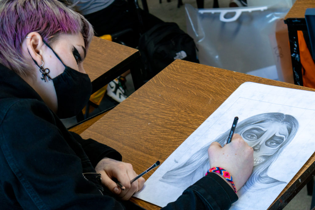 Student drawing her self portrait