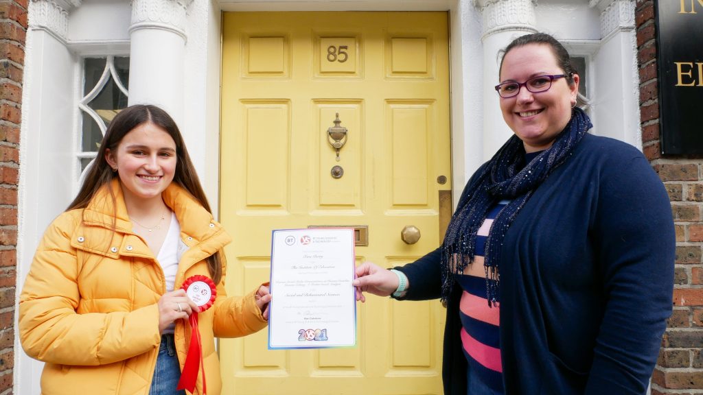 Tara Berry receiving a certificate 