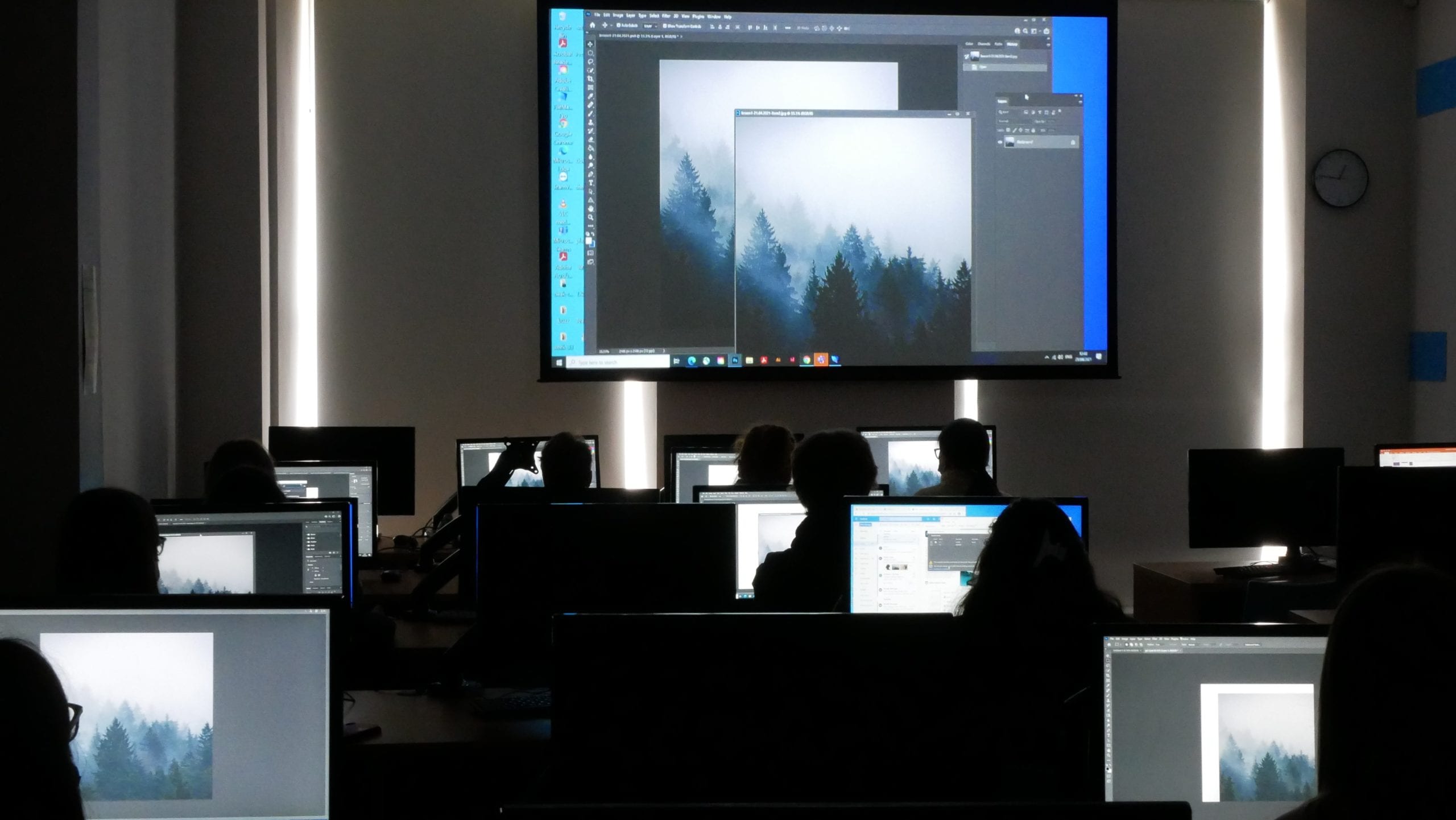 Students replicating what the graphic designer is showcasing them on a whiteboard