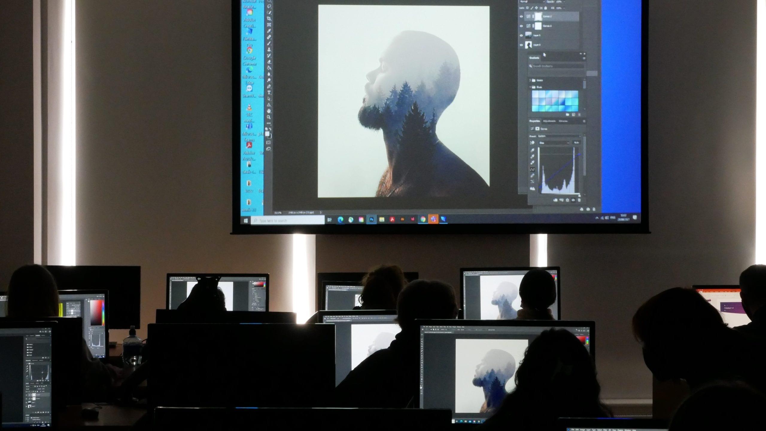 Students replicating what the graphic designer is showcasing them on a whiteboard