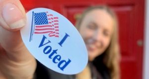 Photo of Zana holding voting badge