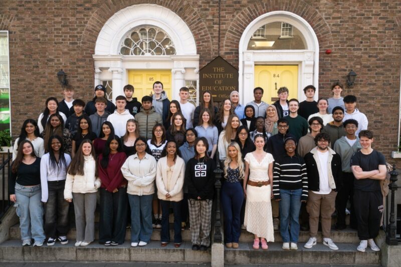 A large group of Institute of Education students gathered on the steps outside the school's Georgian building for a group photo.