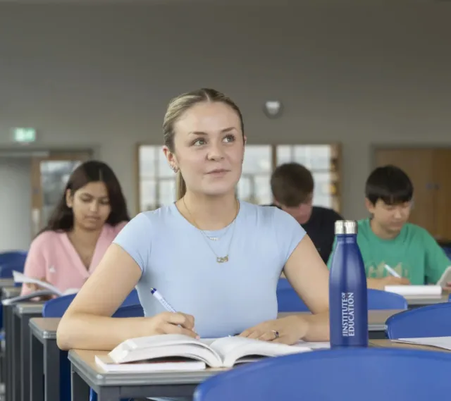 Student taking notes in class