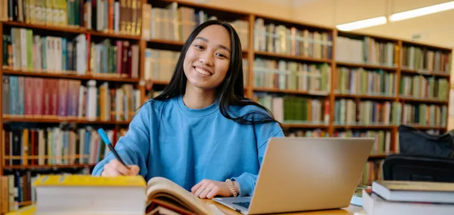 Student in library on her laptop