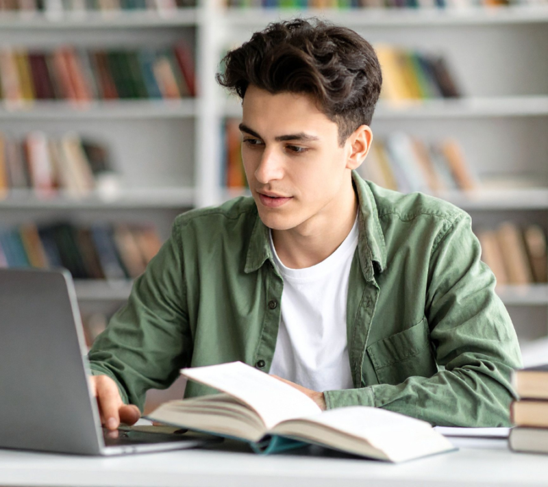 Student on his laptop at the library