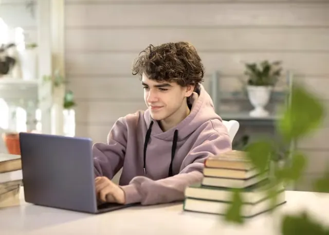 young-man-student-studying-home-looking-laptop_501655-8