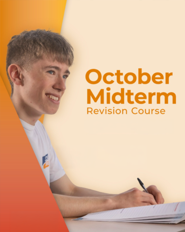 A smiling student writing in a notebook at the Institute of Education during an October Half-Term Revision Course.